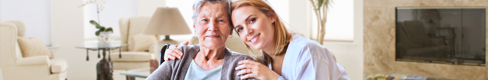 senior woman and caregiver smiling